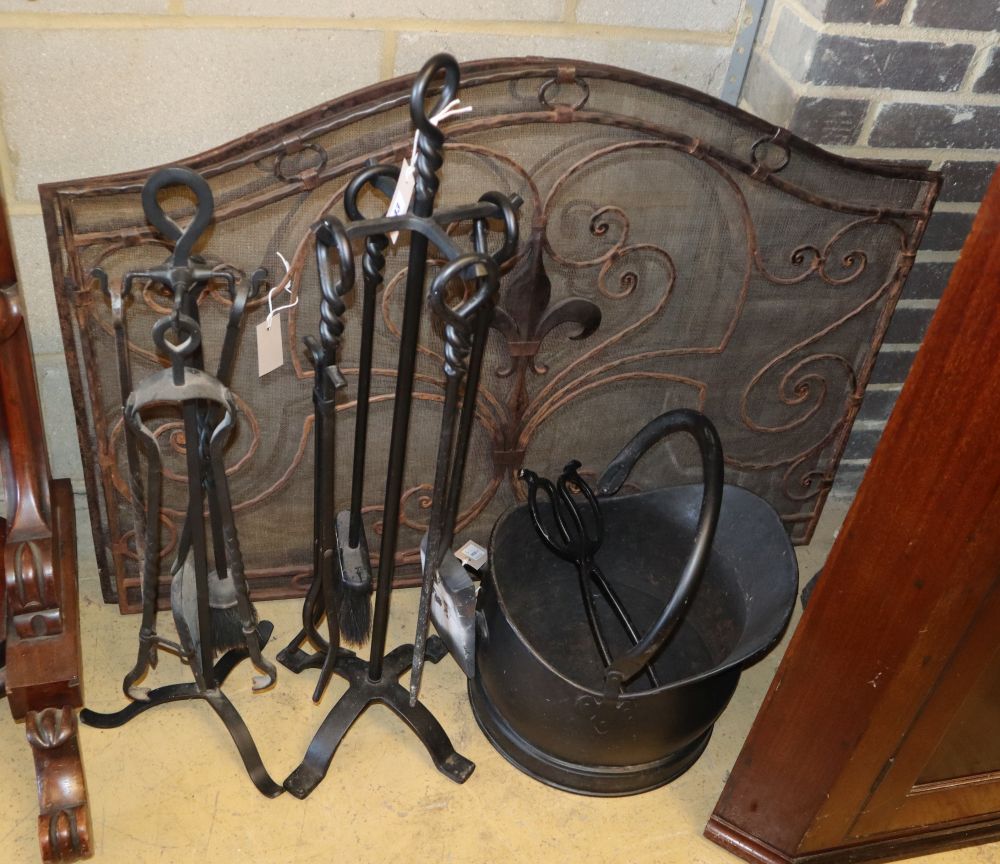 A wrought iron companion set, a coal helmet and a pair of wrought iron and mesh fire guards, guards 100cm x 75cm